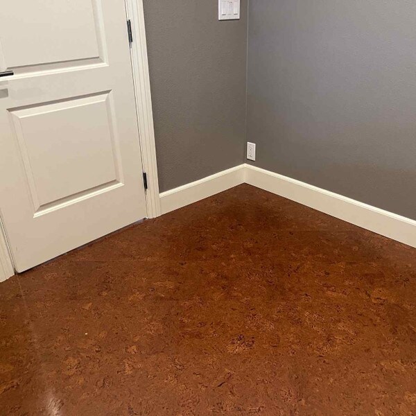 Sierra brown cork flooring in an empty room with medium grey paint and white trim